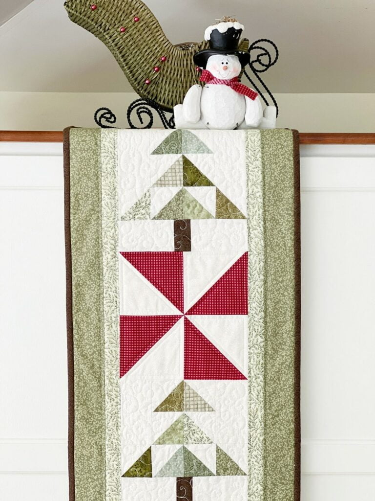Peppermint Woods Table Runner Pattern draped with snowan