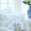 Stardust Shimmer Quilt displayed over chaise with Blue Vase