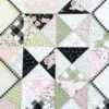 Rhapsody Whirl table runner pattern that is perfect for 1 charm pack & features a zigzag edge.