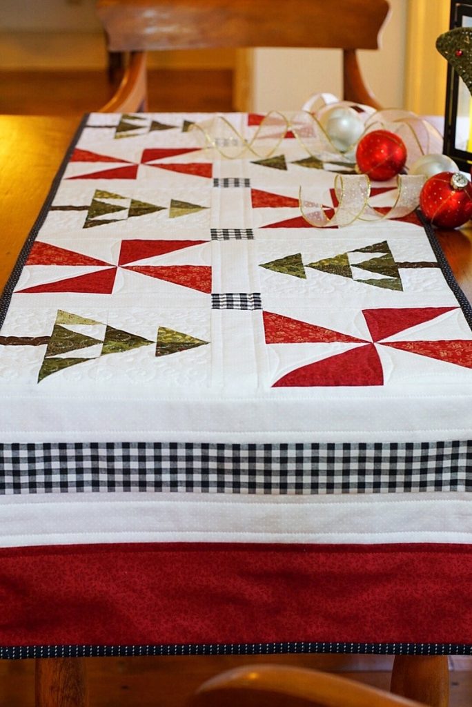 An Evergreen Christmas table runner perfect for holiday decor!
