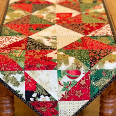 Holiday Diamonds Table Runner Pattern over wood table Holiday Diamonds Table Runner Pattern draped over wood table