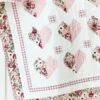 Heart To Heart quilt hanging on cabinet